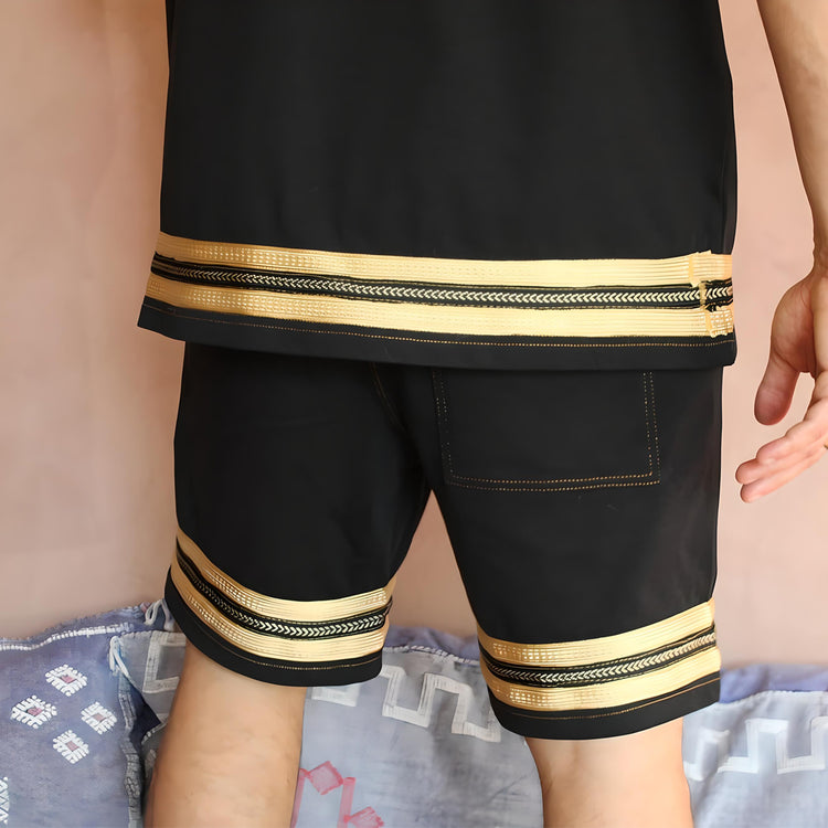 View from the back of the Kaizo-Ku Moroccan Heritage Black and Gold Caftan Shorts, showcasing the luxurious gold Mfira embroidery against the high-quality black fabric. The intricate detailing provides a striking contrast, highlighting the exceptional craftsmanship.