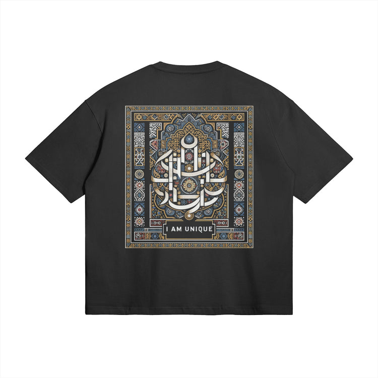 This image showcases the back of our oversized black t-shirt, featuring an intricate Moroccan-inspired traditional design. The bold "I AM UNIQUE" calligraphy is surrounded by detailed geometric patterns in blue and gold, highlighting the cultural essence of this unique piece.