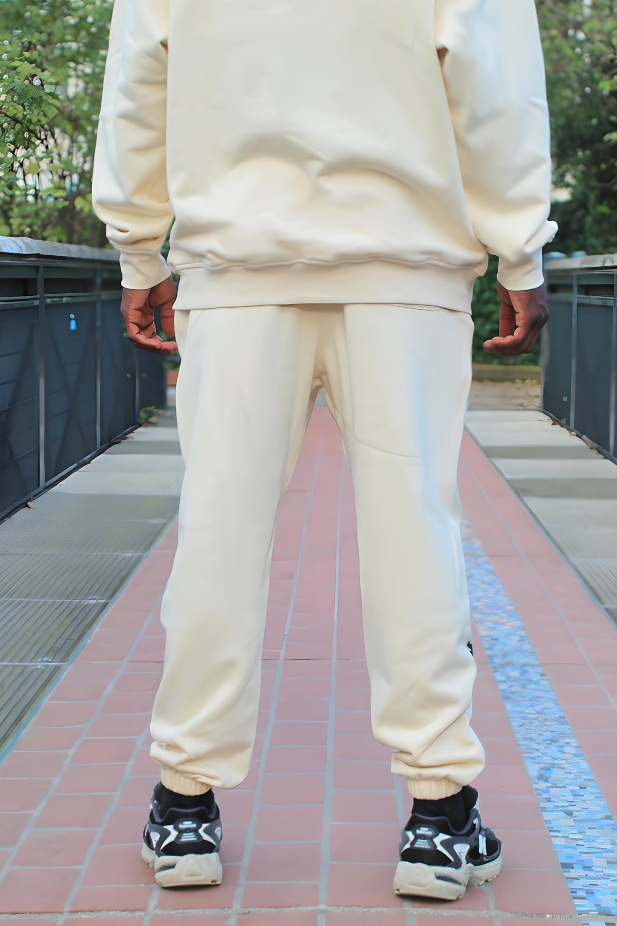 Back view of the Kaizo-Ku beige jogger, showing the clean lines and subtle stitching details.