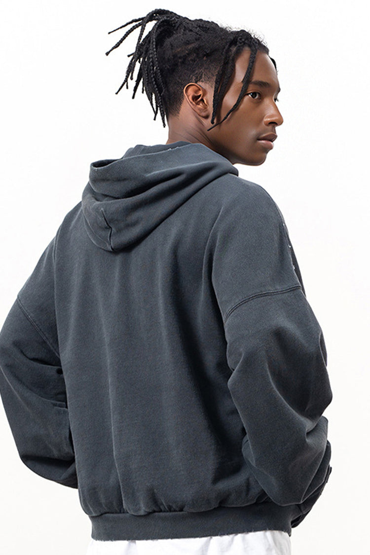 Back view of the Kaizo-Ku Distressed Skull Hoodie worn by a model, highlighting the distressed finish and oversized fit for a bold urban look.
