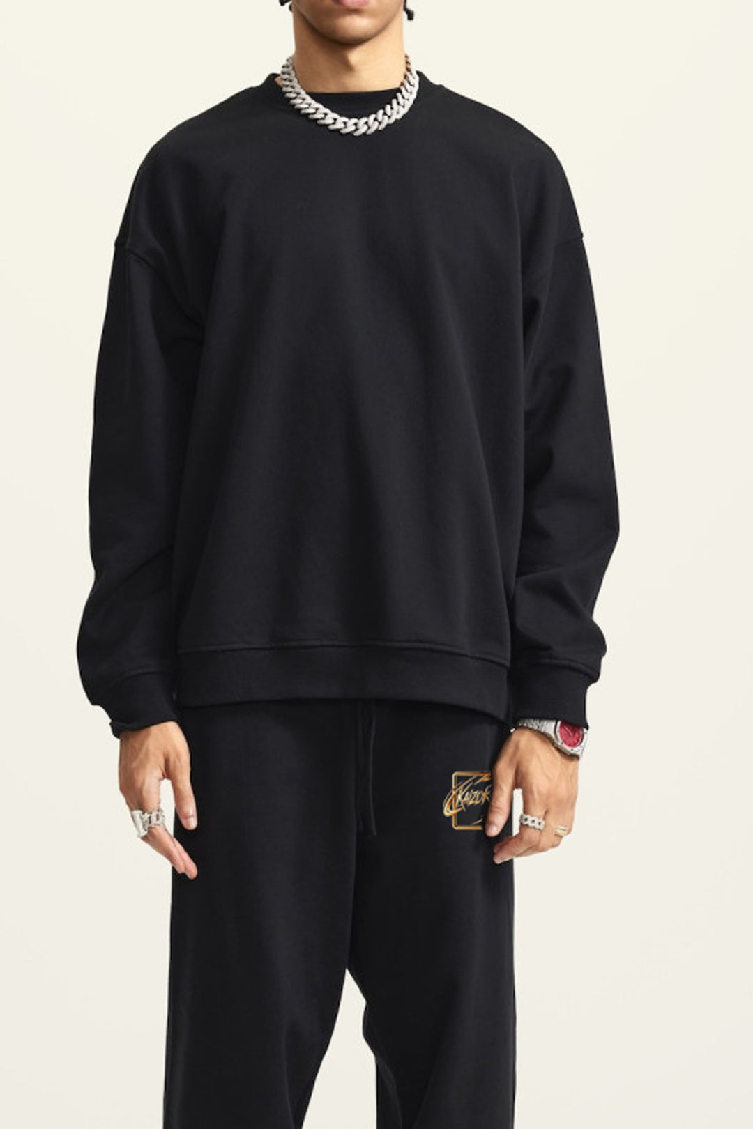 a model wearing the sweatshirt and the jogger matched set kaizoku gold from front