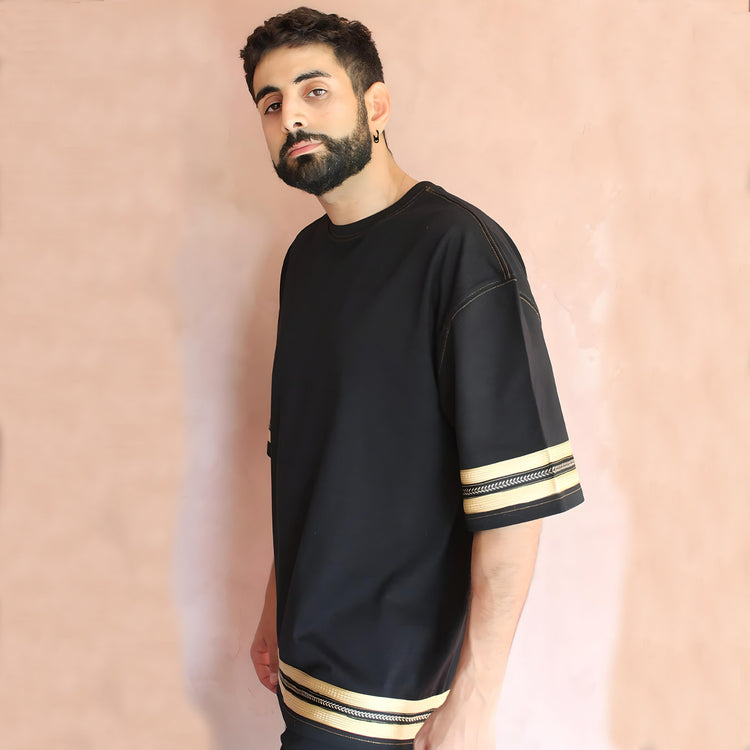 The model presents a stylish profile view, highlighting the t-shirt's elegant design and the seamless integration of sfifa silk trims for a chic urban look.