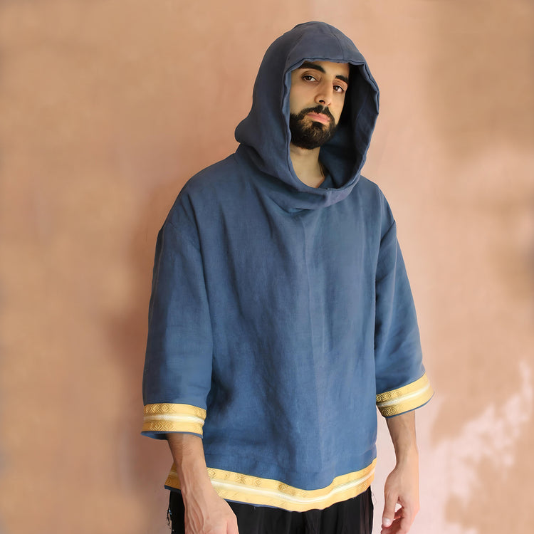 Model wearing the hoodie with the hood up, emphasizing the relaxed fit and urban style influence.