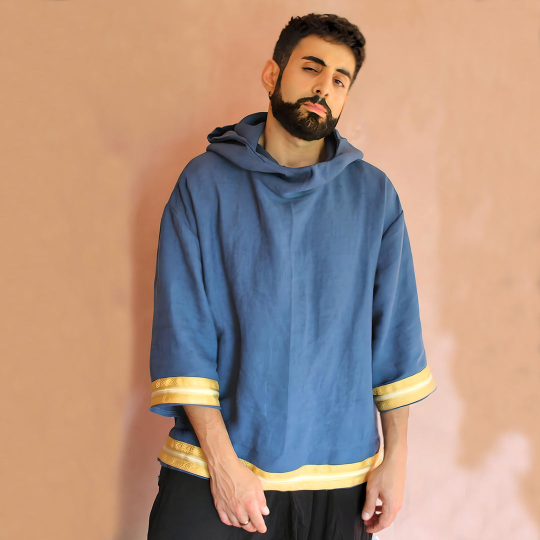 Front view of the hoodie displaying the rich blue linen material and the golden trims that add a touch of luxury.