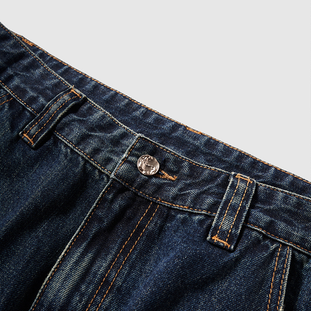 A close-up of the button and waistband, showcasing the quality stitching and durable hardware on the blue denim jeans.