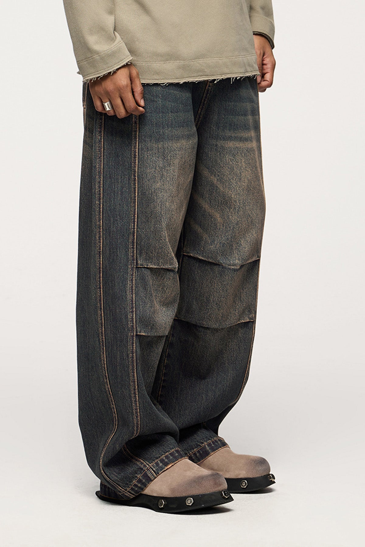 A front and side view of the blue denim jeans, highlighting the wide-leg cut and structured design.