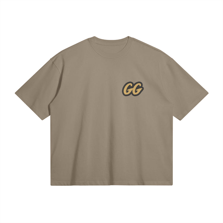 Front view of the Barjoo_Tv Oversized T-shirt in light brown, featuring the sleek "GG" emblem.