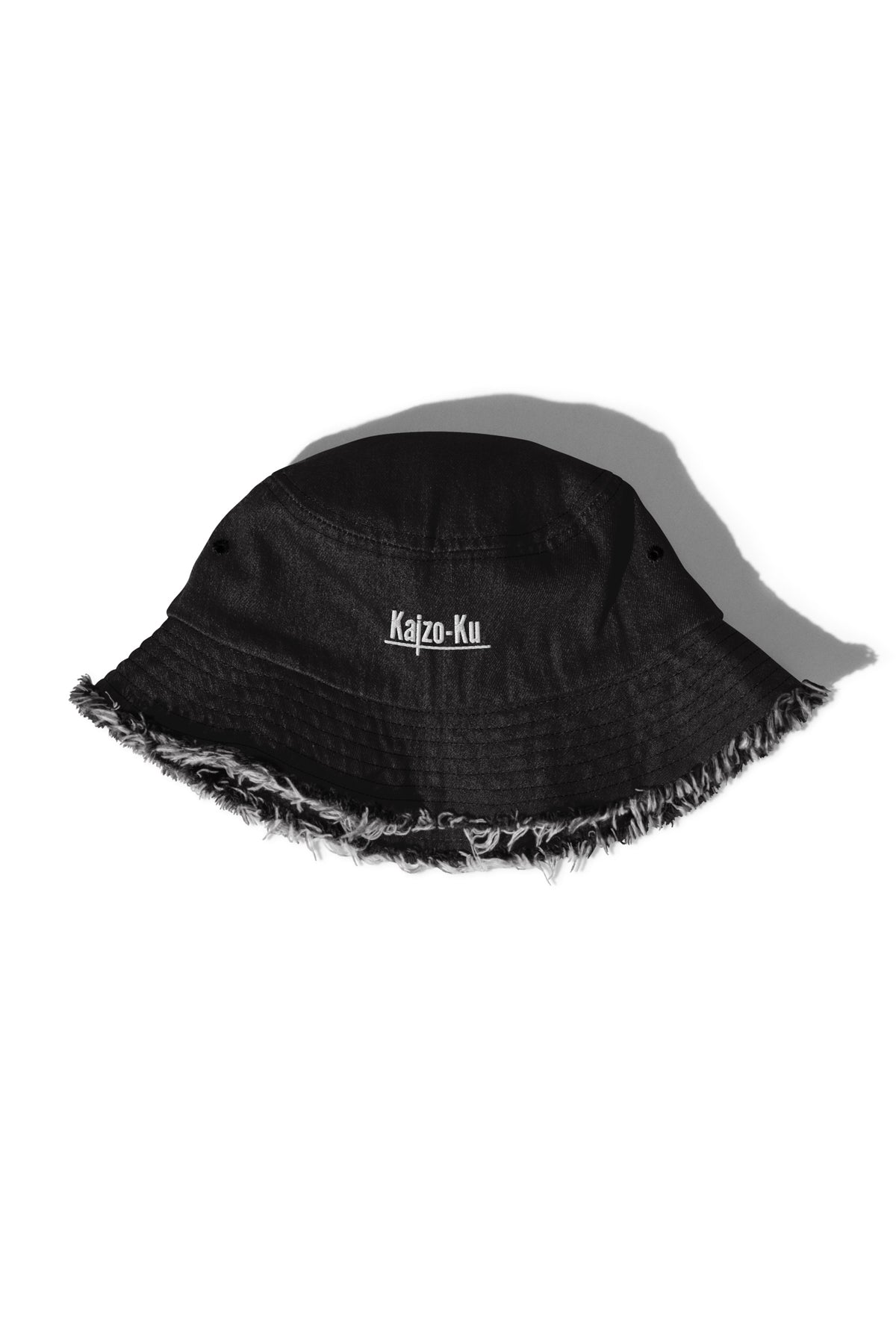 Side detail of the Kaizo-Ku Distressed Denim Bucket Hat in Black, displaying the raw, distressed fabric that embodies urban streetwear