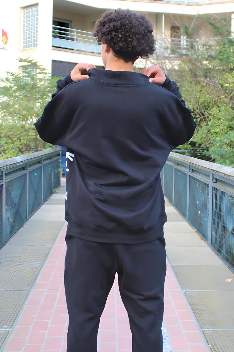 Back view of the Kaizo-Ku black half-zipped sweatshirt, highlighting the smooth fabric and relaxed fit.