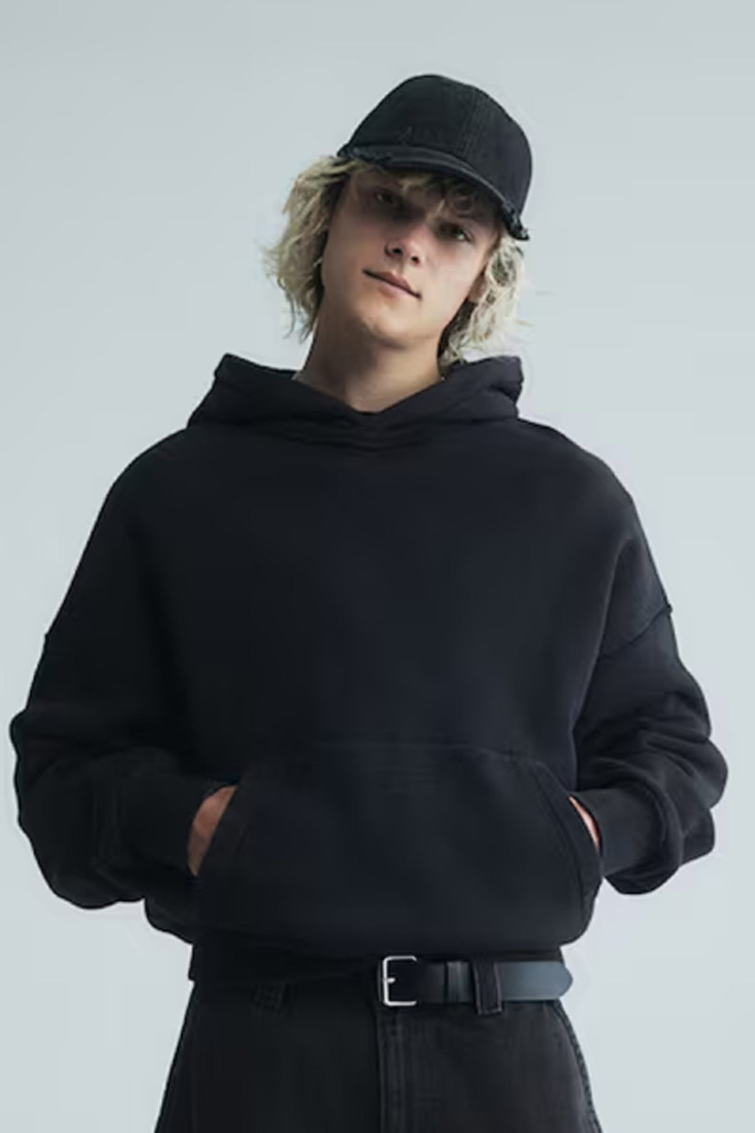 a streetwear design piece with a model wearing the kaizo-ku angel hoodie seen from the front