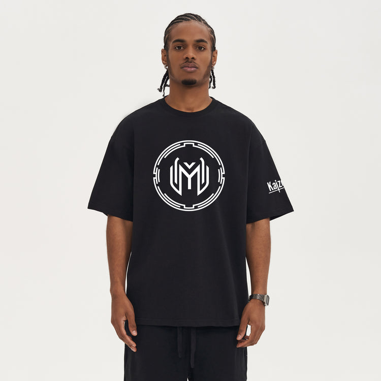 Un modèle portant le t-shirt oversized Kaizo-Ku x Maze avec le logo minimaliste. Un design épuré et un confort optimal pour un look casual et streetwear.