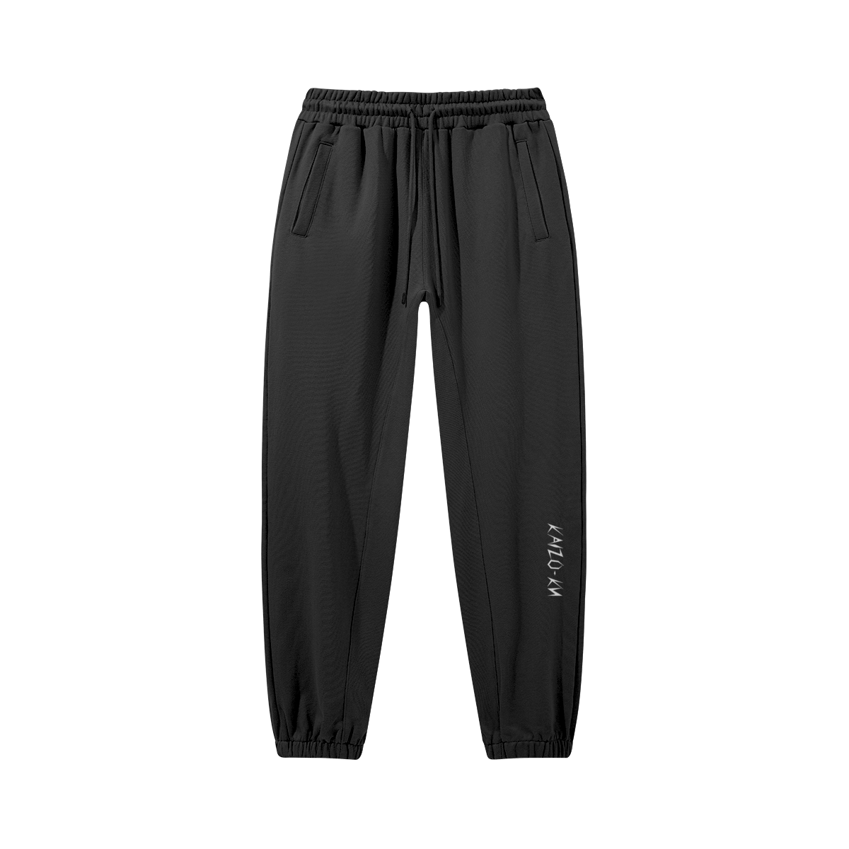 Flat front view of the Kaizo-Ku oversized jogger in Black. The embroidered logo on the left shin adds a subtle, stylish detail to this oversized piece.