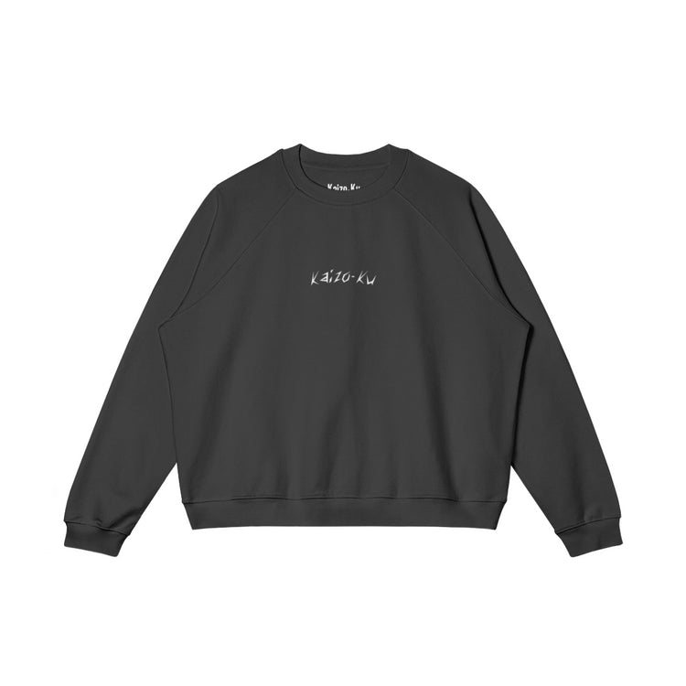 Front view of the oversized sweatshirt from Kaizo-Ku in Black, featuring the subtle embroidered "Kaizo-Ku" logo on the chest. A minimalistic yet bold streetwear piece.