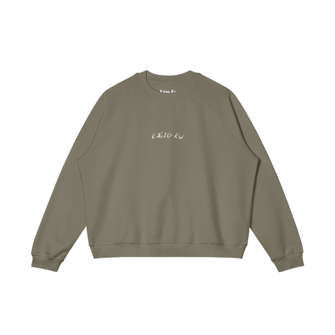 Front view of the oversized sweatshirt from Kaizo-Ku in Camel. Minimalistic with the embroidered "Kaizo-Ku" logo on the chest, for a stylish yet understated streetwear look.