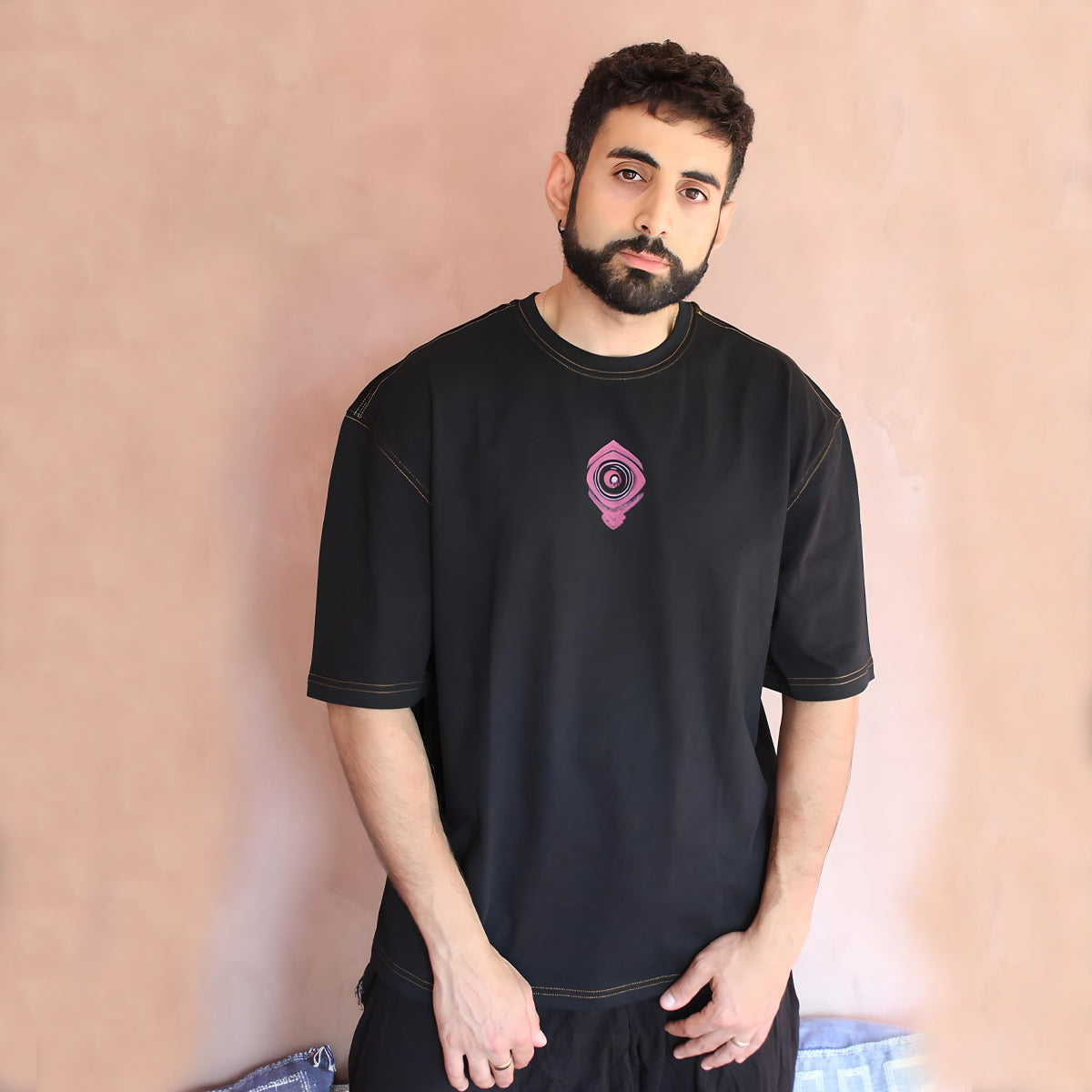 Embrace the urban elegance with our Sunny Blossom Oversized Black T-Shirt. The front features a subtle yet striking graphic that perfectly blends contemporary streetwear aesthetics with timeless design. Crafted for comfort and style, this oversized fit t-shirt is a must-have for those who appreciate both fashion and function. Perfect for casual outings or making a statement on the streets, this t-shirt speaks volumes without saying a word.