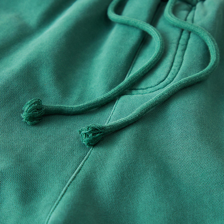 Zoom in on the elegance and functionality of our Fuchsia Green joggers with a detailed look at the waist drawstrings. Designed for a perfect fit and refined appearance, they merge practicality with style for ultimate comfort.