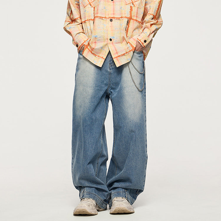 Front view of the Kaizo-Ku Upside Down Denim Jeans worn by a model. These jeans feature a relaxed fit with wide legs, and the innovative upside-down design gives them an edge in street fashion.