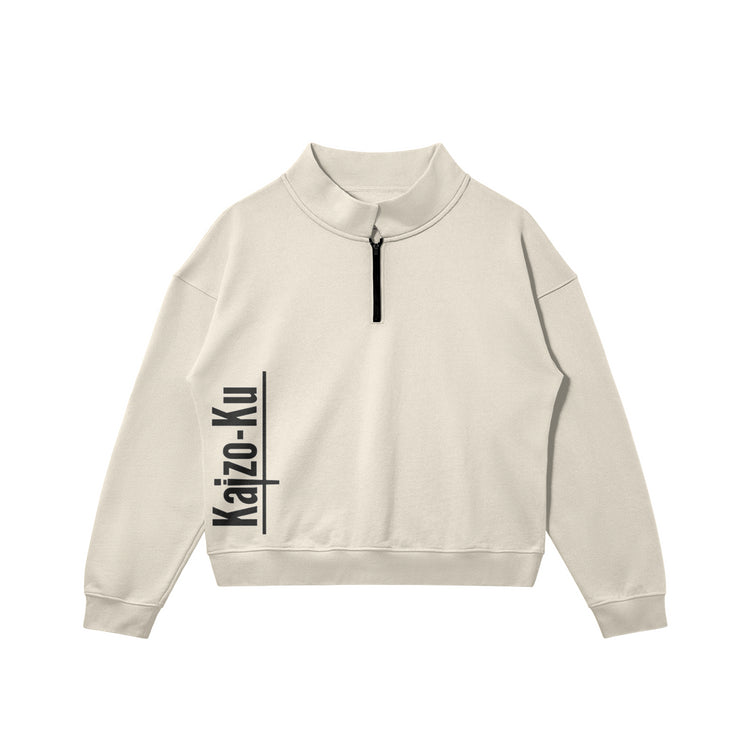 Flat front view of the Kaizo-Ku zip collar sweater in Beige, featuring the printed "Kaizo-Ku" logo on the right side. Minimalistic streetwear design with a modern zip collar.