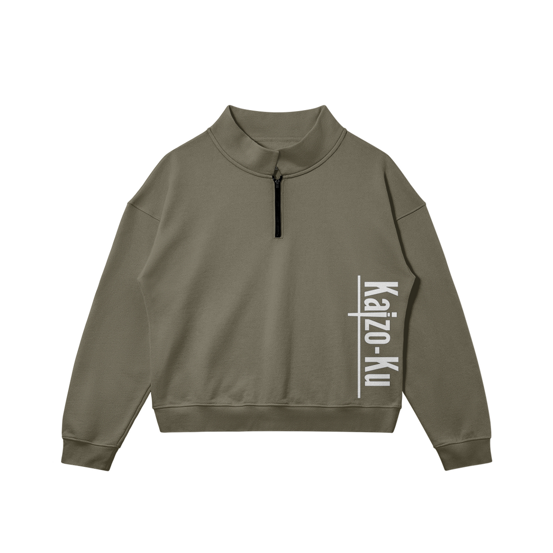 Flat front view of the Kaizo-Ku zip collar sweater in Khaki, featuring the white printed "Kaizo-Ku" logo on the right side. Perfect for layering or wearing on its own.