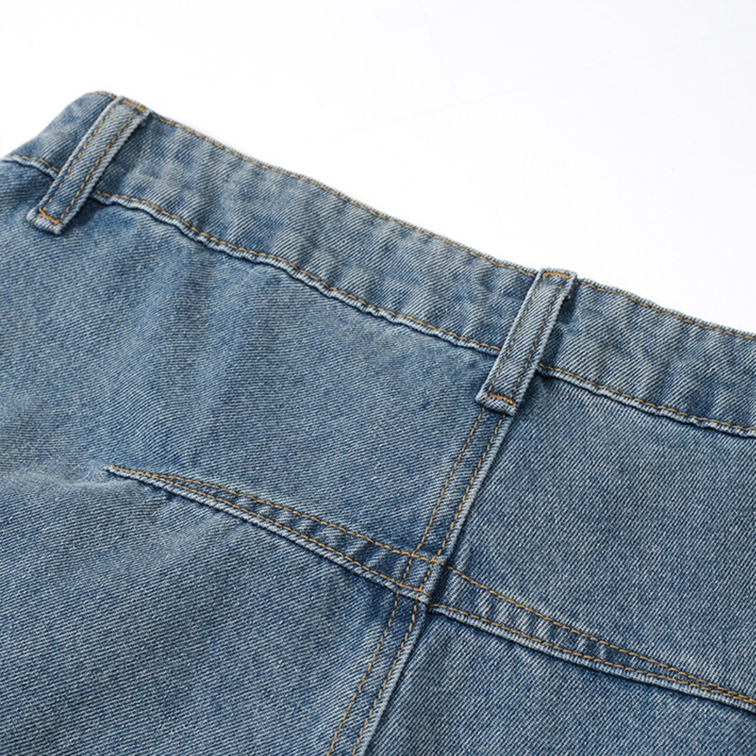 Close-up of the back waist section of the Kaizo-Ku Upside Down Denim Jeans. The design highlights the unique placement of pockets and details flipped to the lower legs.
