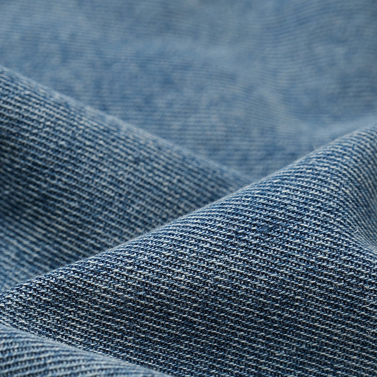 Close-up of the denim fabric used for the Kaizo-Ku Upside Down Denim Jeans. The high-quality, light-wash denim ensures comfort and durability, with a soft texture perfect for everyday wear.