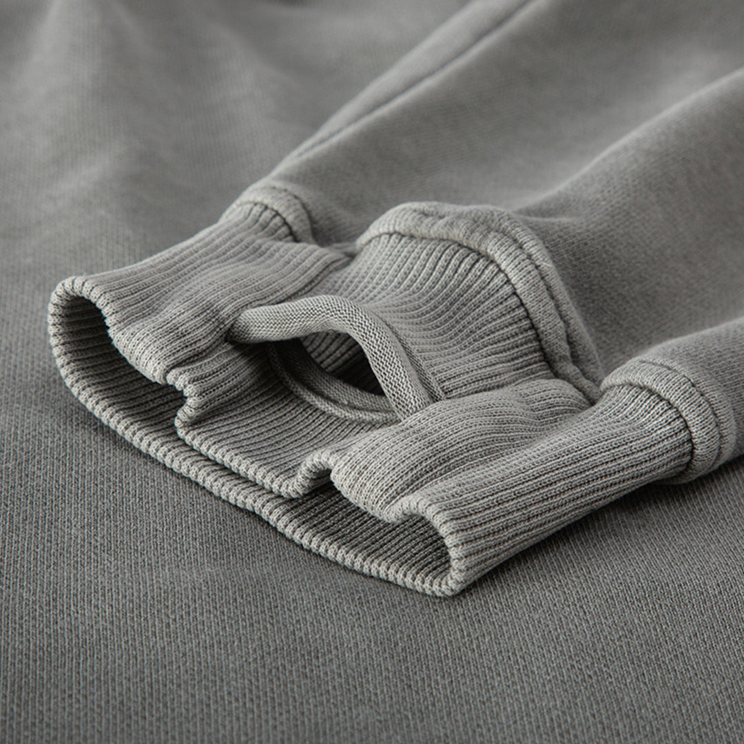 Detailed view of the thumb hole in the sleeve cuffs of the Kaizo-Ku hoodie, providing practicality and a secure fit.
